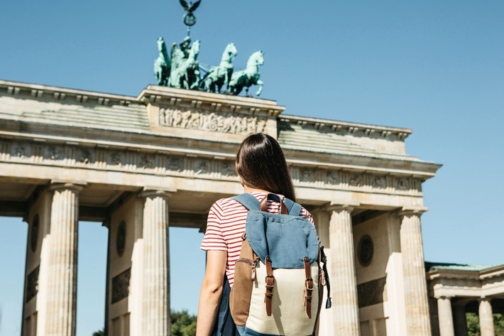 A tourist or a student with a backpack near the Brandenburg Gate
